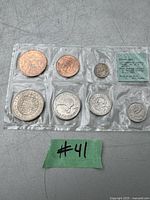 Plastic holder containing seven New Zealand coins from 1965 in uncirculated condition.