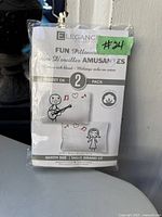 Image of the original packaging for a pair of queen size pillow cases from Elegance Collection, brand new in bag, featuring fun cartoon style graphics.