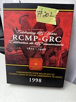 Front view of commemorative coin packaging showing RCMP 125 years celebration logo and Royal Canadian Mint branding.