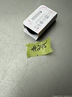 Photo of a new Samsung EP-TA USB-C cable in partially opened original white cardboard packaging showing product symbols and details on the packaging.