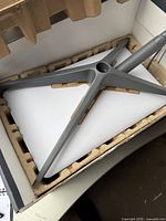 Tripod mounting base for the Starlink dish inside molded cardboard packaging within the box.