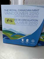 Front cover of the folder showing Royal Canadian Mint Vancouver 2010 circulation coins packaging with bilingual text and Olympic logos.