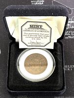 The coin displayed in a velvet box with an included Certificate of Authenticity from the US Mint.