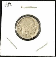 Obverse view showing the Native American profile dated 1919, secured in a white cardboard holder with a clear plastic window.