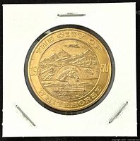 Obverse showing City of Whitehorse with mountain, train, and steamboat design dated 1950.