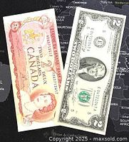 Photo showing both banknotes side by side on a map background - Canadian $2 note on left with Queen Elizabeth II portrait, US $2 note on right with Thomas Jefferson portrait.
