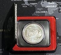 Side angle view showing the protective case of the 1974 Canadian silver dollar coin with red velvet interior, highlighting overall condition and presentation of the coin.