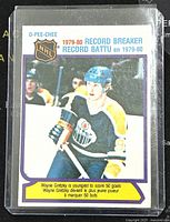 Front of card showing Wayne Gretzky in Oilers uniform with NHL shield logo and text about record breaking achievement.
