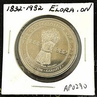 Front side of the 1982 Canadian Elora Ontario Trade Dollar showing wheat sheaf and dates 1832-1982 in protective holder.