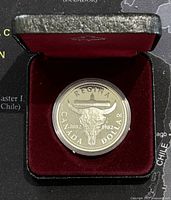 1982 Canadian silver proof dollar coin in black and maroon presentation case.