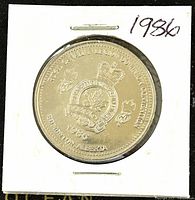 Obverse side of 1986 Canadian Edmonton Alberta Trade Dollar coin showing crown, maple leaf, and text