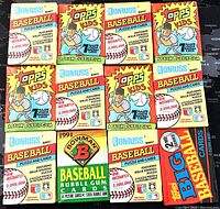 Front view showing 12 unopened assorted baseball trading card packs from various 1990s brands including Topps Kids, Donruss, Bowman, and Topps Big.