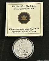 Photo of the folded informational card with title and the coin in protective casing.