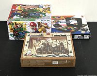 Three boxed games displayed together: Super Mario Adventure Game DX, Rubik's Race, and Labyrinth