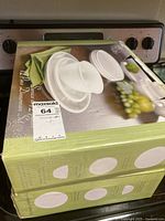 Boxed 12 piece white dinnerware set with original packaging showing set includes plates and bowls.