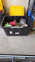Large black plastic bin containing multiple metal spools with electrical wire, some connectors and loose wire visible inside.