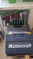 Photo of electrician's tool set in pouch and Mastercraft ratchet set carrying case stacked on top of each other.