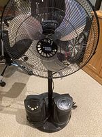 Front view of the Black & Decker pedestal fan showing metal grille and control panel at base