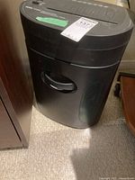 Front and full view of the black Royal shredder showing overall shape and bin with handle.