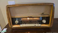 Full front view of wooden cabinet radio on table