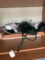 Overview of various electrical cords, power strips, and extension cords, including a green heavy-duty cord and a white cube-style power strip