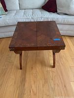 Top view showing inlaid wood pattern on closed table surface.