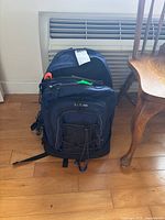Front view of dark blue L.L. Bean backpack with visible label and bungee cord on front pouch