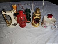 Full set of items with cup, brush, razor, three small lanterns and Avon aftershave bottles.