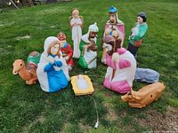 Full set of 11 nativity blow mold figurines arranged on lawn