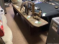 Overall view of bench showing top surface, legs, and surrounding items