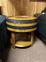 Front view showing round tabletop, Jack Daniels logo facing forward, four legs and lower shelf visible