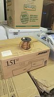 Sealed Bose 151 SE speaker box with spool of speaker wire on top