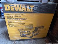 Front of box showing DEWALT logo, product name and image of table saw