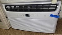 Front view of white Frigidaire window air conditioner with grille and control display area.