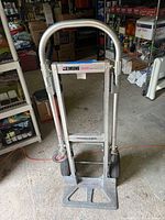 Front view of Magliner Gemini convertible hand truck standing upright showing wheels, handle, and platform.
