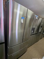Front view of LG French door refrigerator among other appliances