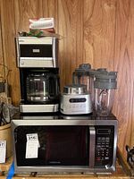 Ninja blender on top of Faberware microwave with Braun coffee pot on microwave