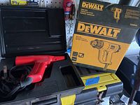 Dewalt heat gun near original box and Snap-On carrying case on shelf