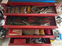 Open Snap-On tool chest drawers showing pliers, screwdrivers, wires, and other hand tools