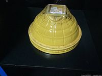 Bottom view showing the McCoy pottery mark and yellow glaze with checkered texture.