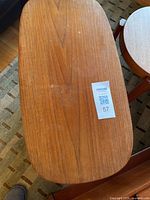 Top view of teak magazine table showing oval top surface and wood grain