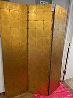 Full view of the folding room divider screen showing three foldable panels with the gold leaf finish and grid pattern.