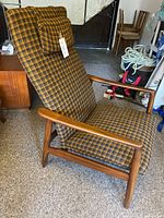 Side profile of recliner showing teak wood frame and upholstery