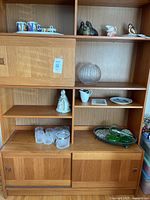 Front view of teak wall unit with shelving and cabinets