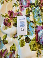 Close-up of fabric with floral print and blackout lining noted, showing texture and colors