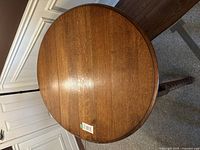 Top view of the oval drop leaf table showing the medium wood tone and surface condition