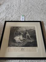 Full view of the black framed engraving print under glass showing two dogs sitting outdoors.