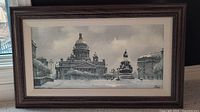 Full view of the framed painting showing the cityscape with dome and statue in snow