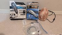 Lot showing packaged Wahl Elite Pro shaver kit, Barber In A Box kit, salt lamp, and Homedics Sound Spa device in plastic bag