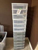 Stacked sets of four clear plastic storage drawer units, showing overall size and drawer count.